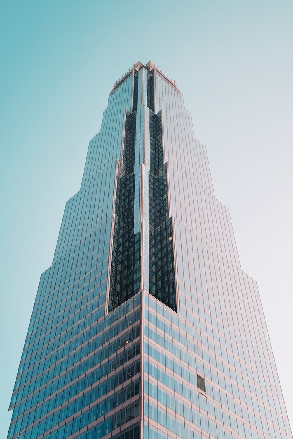 A modern glass office tower rising against an open sky